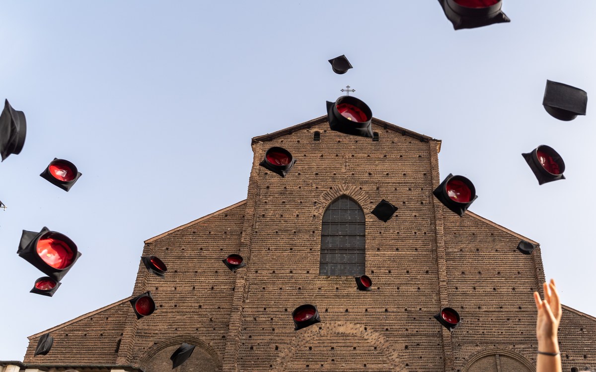 throwing of academic caps in front of San Petronio