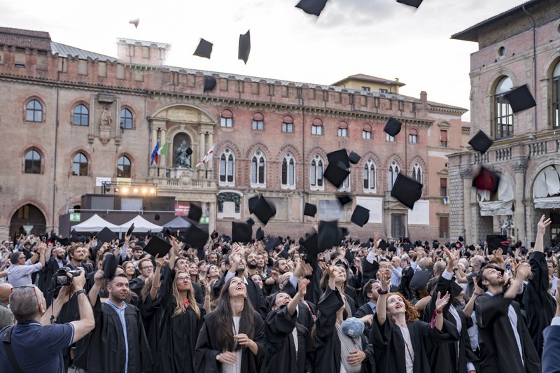 PhD graduates throw their caps into the air