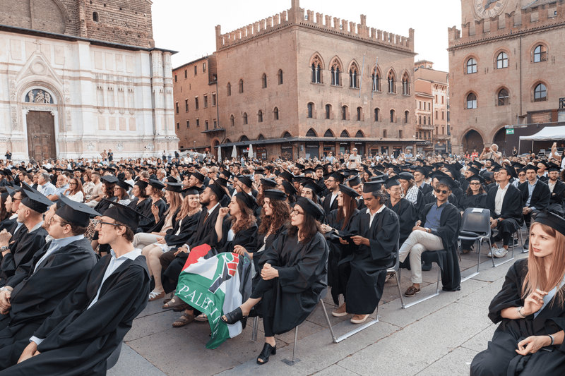 PhD graduates in gown and cap attend the ceremony